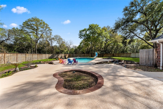 view of pool with a water slide and a patio