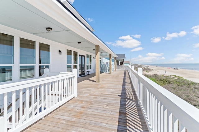 deck featuring a beach view and a water view