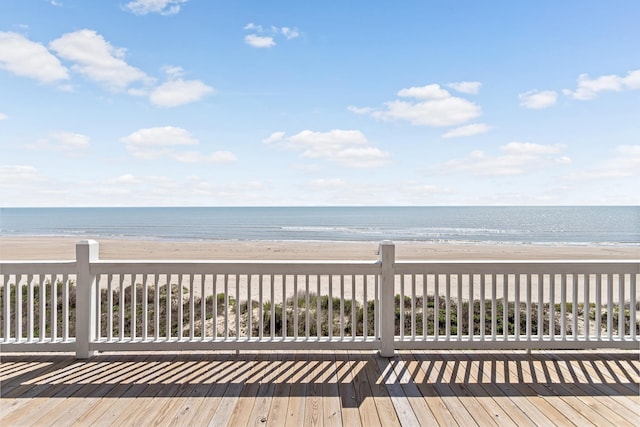 deck featuring a beach view and a water view