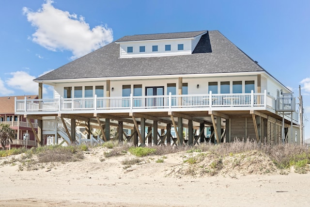 rear view of property featuring a wooden deck