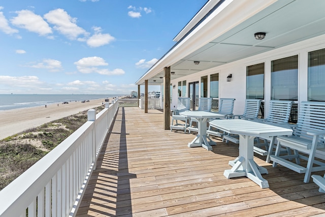 deck with a beach view and a water view