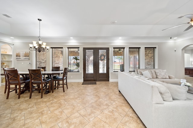 living room with ornamental molding and ceiling fan with notable chandelier