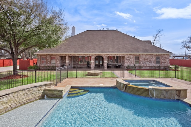 view of pool featuring an in ground hot tub, a patio area, pool water feature, and a lawn