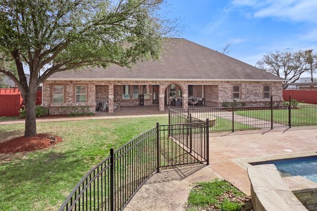 exterior space with a patio, a yard, and a swimming pool