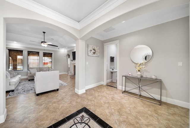 living room with ornamental molding and ceiling fan