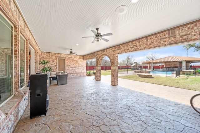 view of patio / terrace with ceiling fan, a fenced in pool, and an outdoor hangout area