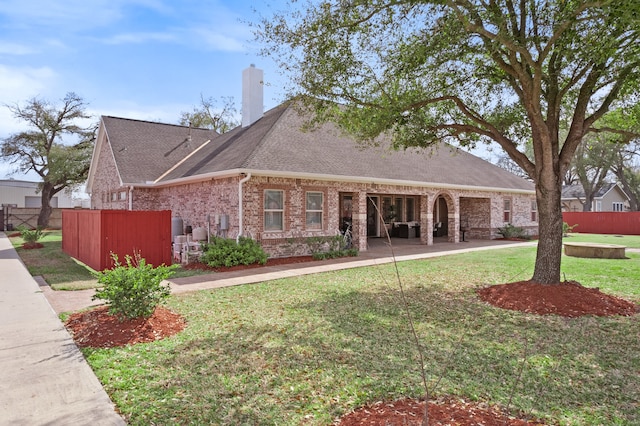 view of front facade with a patio area and a front lawn