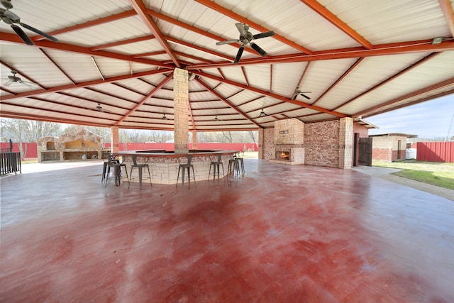 interior space with a gazebo, exterior bar, and ceiling fan