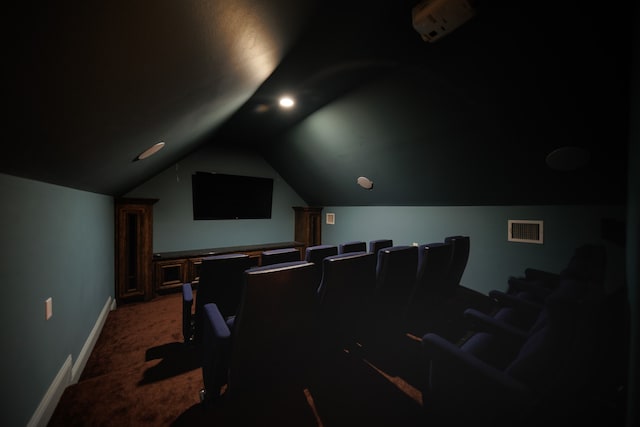 cinema featuring lofted ceiling and dark colored carpet