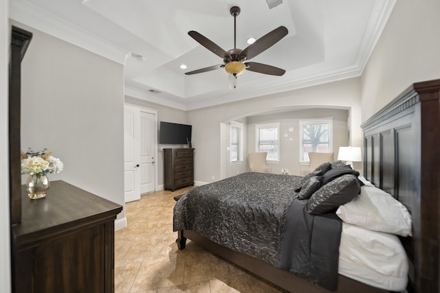 bedroom featuring ceiling fan, a raised ceiling, and ornamental molding