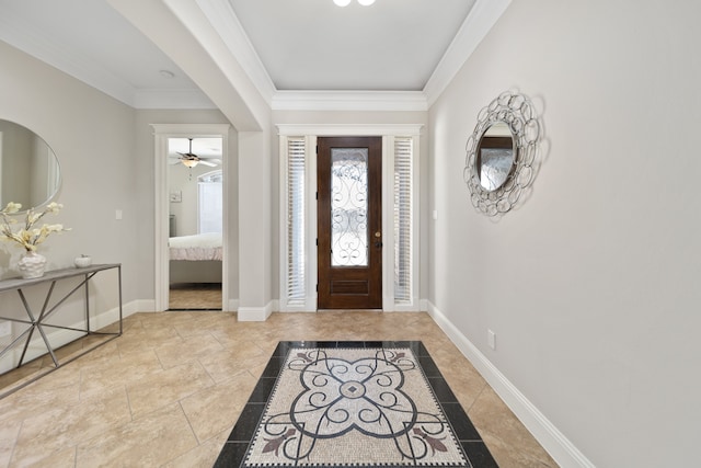 entrance foyer featuring ceiling fan and ornamental molding