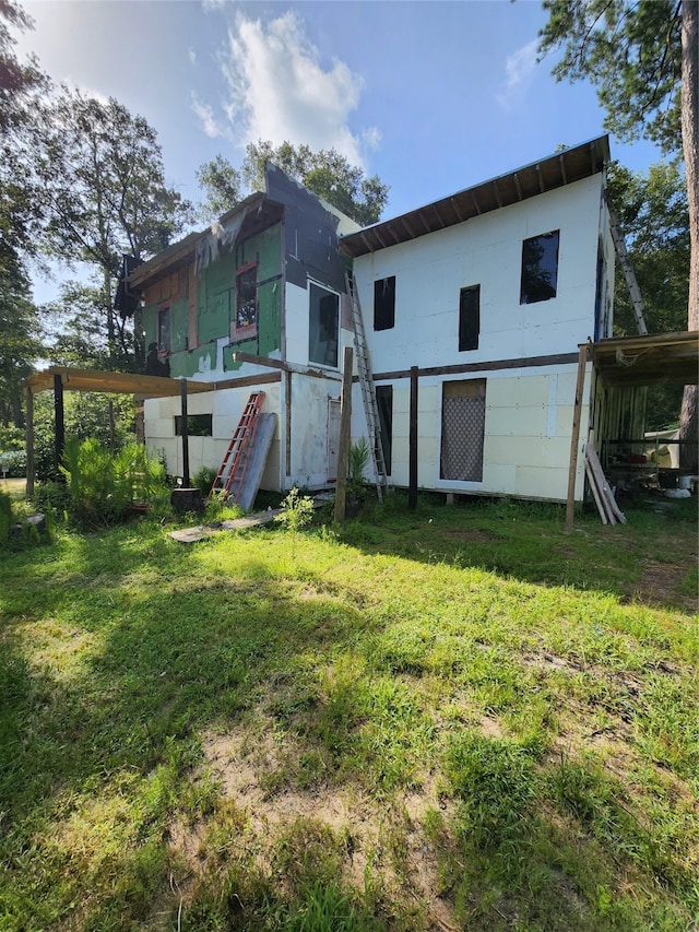 rear view of house with a lawn