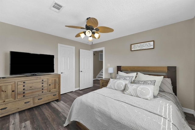 bedroom with ceiling fan and dark hardwood / wood-style floors