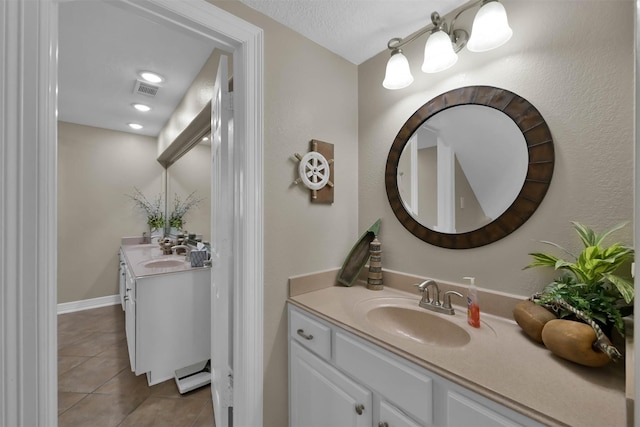 bathroom featuring vanity, tile patterned flooring, and a textured ceiling