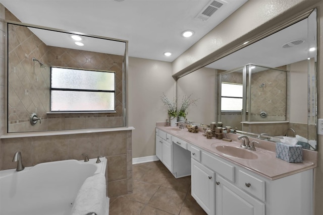 bathroom featuring a washtub, tile patterned flooring, a wealth of natural light, and vanity