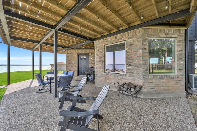 view of patio / terrace with a water view and grilling area