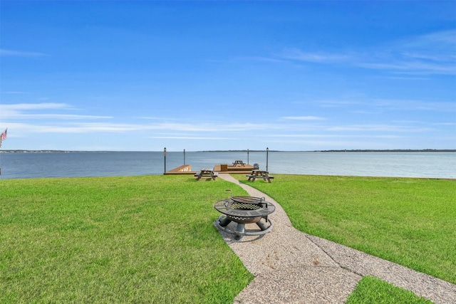 view of yard with a fire pit and a water view