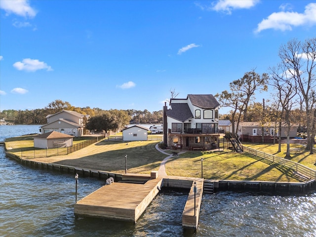 view of dock with a yard and a deck with water view