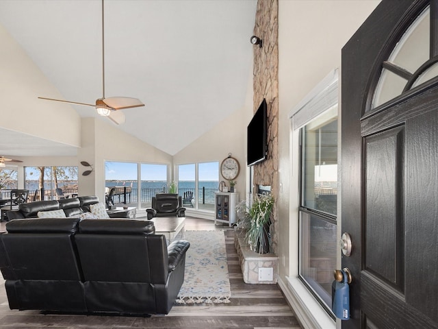 living room with ceiling fan, high vaulted ceiling, and wood-type flooring