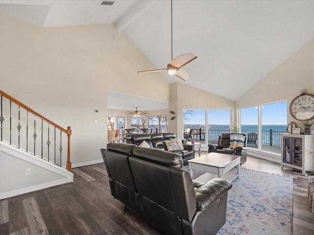 living room with dark wood-type flooring, ceiling fan, beamed ceiling, and a water view