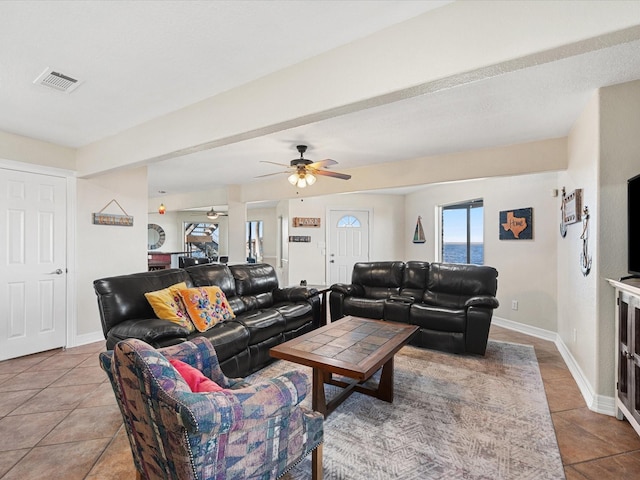 tiled living room featuring ceiling fan