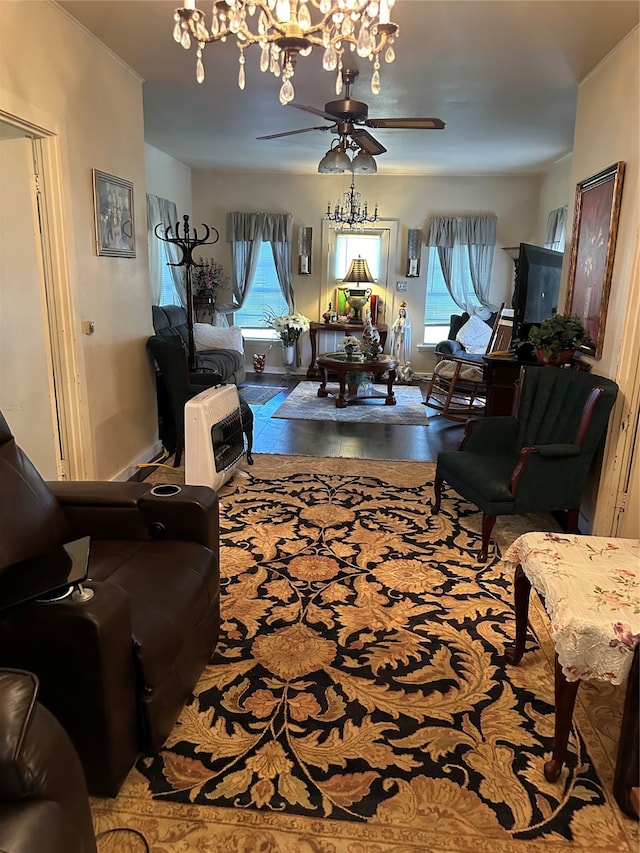 living room with ceiling fan with notable chandelier and light hardwood / wood-style flooring