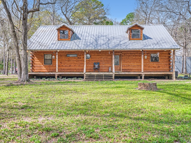 rear view of property with a lawn