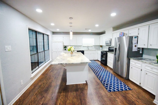 kitchen with pendant lighting, light stone counters, a kitchen island, dark wood-type flooring, and black appliances