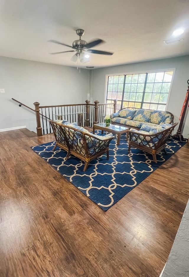 living room featuring dark hardwood / wood-style floors and ceiling fan