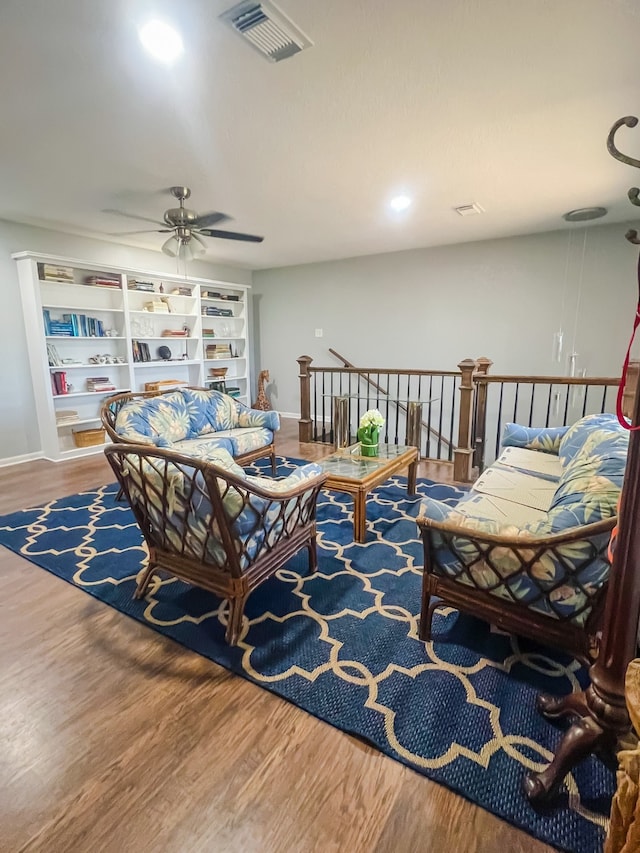 living room featuring ceiling fan and wood-type flooring