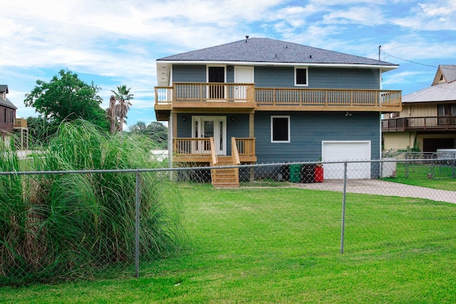 back of house featuring a balcony, a yard, and a garage