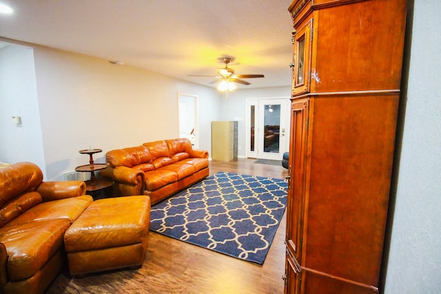 living room with ceiling fan and dark hardwood / wood-style floors