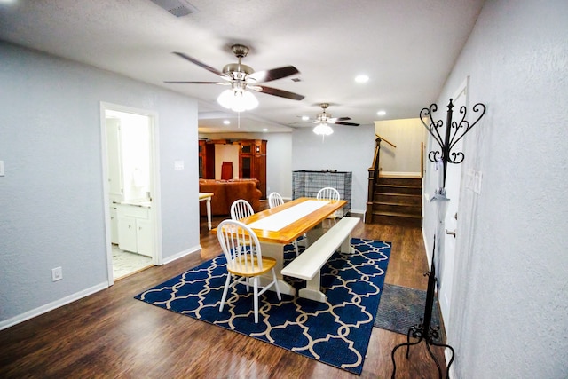 dining area with ceiling fan and dark wood-type flooring