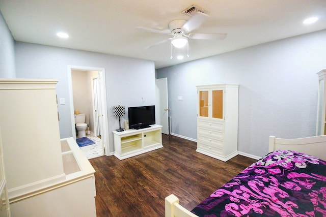 bedroom featuring dark hardwood / wood-style floors, connected bathroom, and ceiling fan