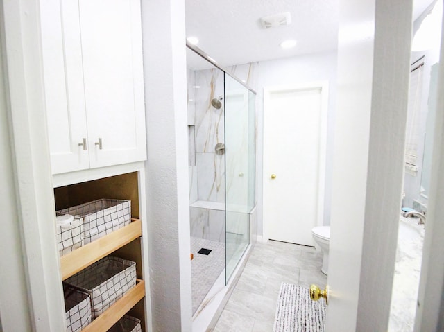 bathroom featuring toilet, tile flooring, and an enclosed shower