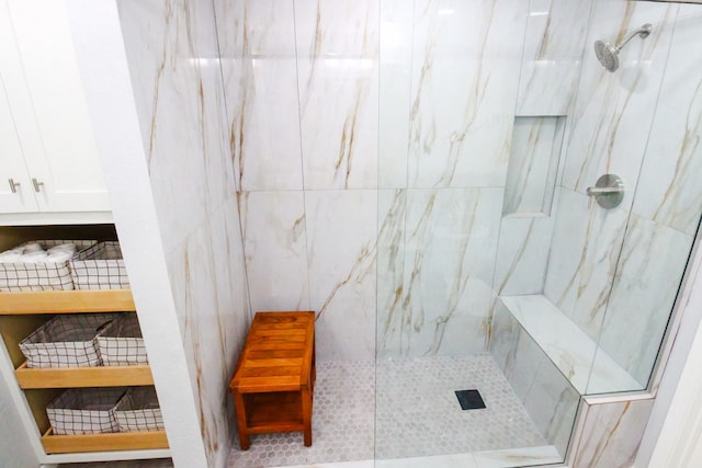 bathroom with tile walls and tiled shower