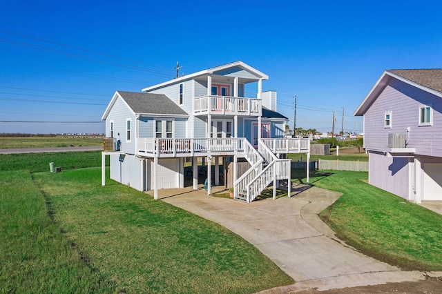 back of house with a yard, a balcony, and a deck