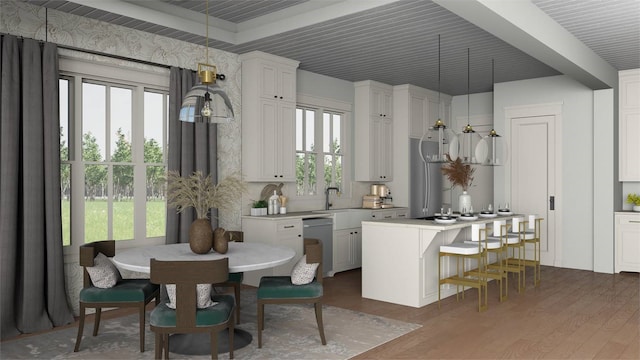 kitchen featuring white cabinetry, a healthy amount of sunlight, and pendant lighting