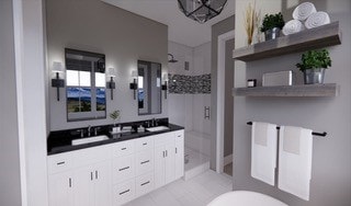 bathroom with double sink, tile floors, large vanity, and a tile shower