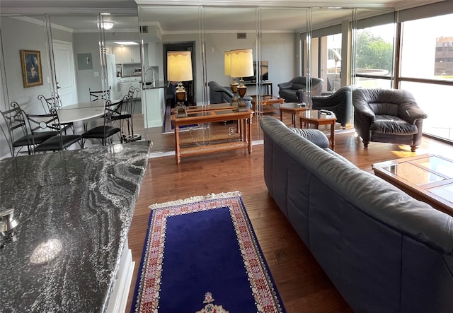 living room with dark hardwood / wood-style floors and crown molding