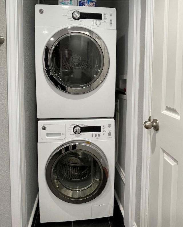 clothes washing area featuring stacked washer / dryer