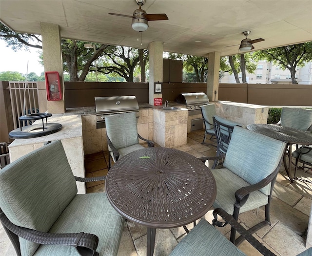 view of patio / terrace featuring ceiling fan, sink, and area for grilling