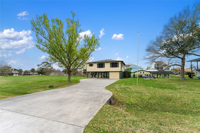 view of front of home with a front yard and a carport