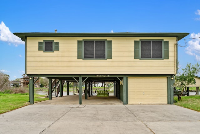 raised beach house with a carport and a garage