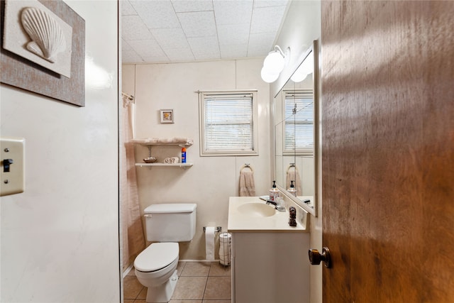 bathroom featuring tile patterned floors, vanity, and toilet