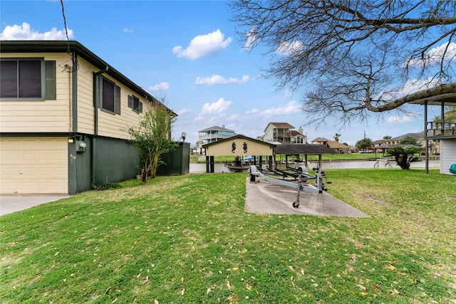 view of yard with a water view and a garage