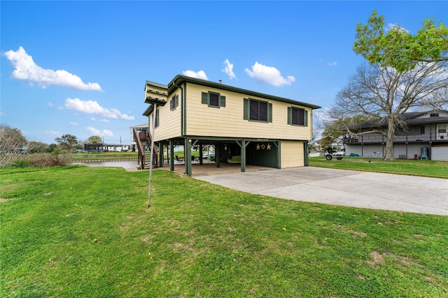 exterior space featuring a yard, a water view, and a carport