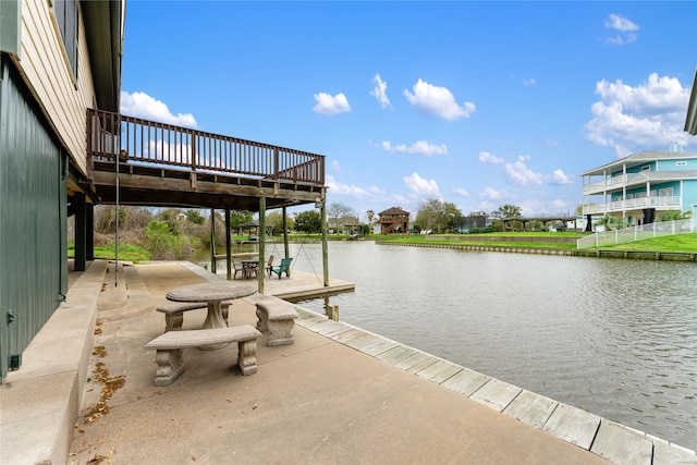 dock area with a patio area and a deck with water view