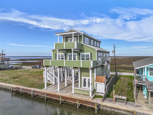 back of house featuring a deck with water view