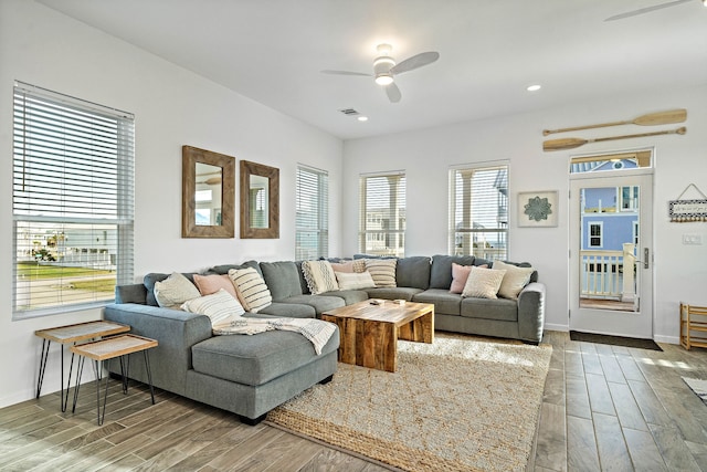 living room featuring light hardwood / wood-style floors and ceiling fan